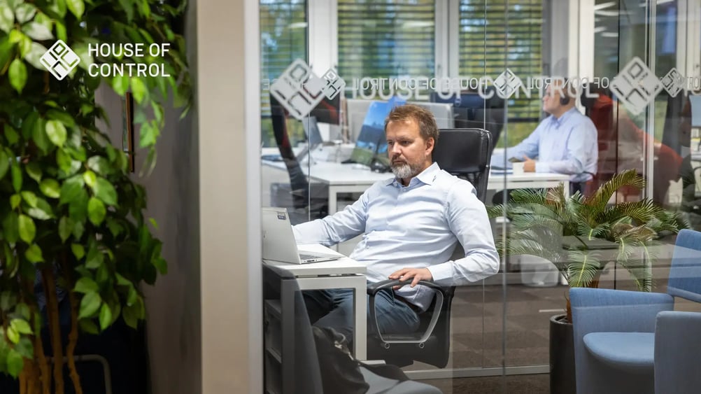 An employee at House of control, sitting down while in a meeting room