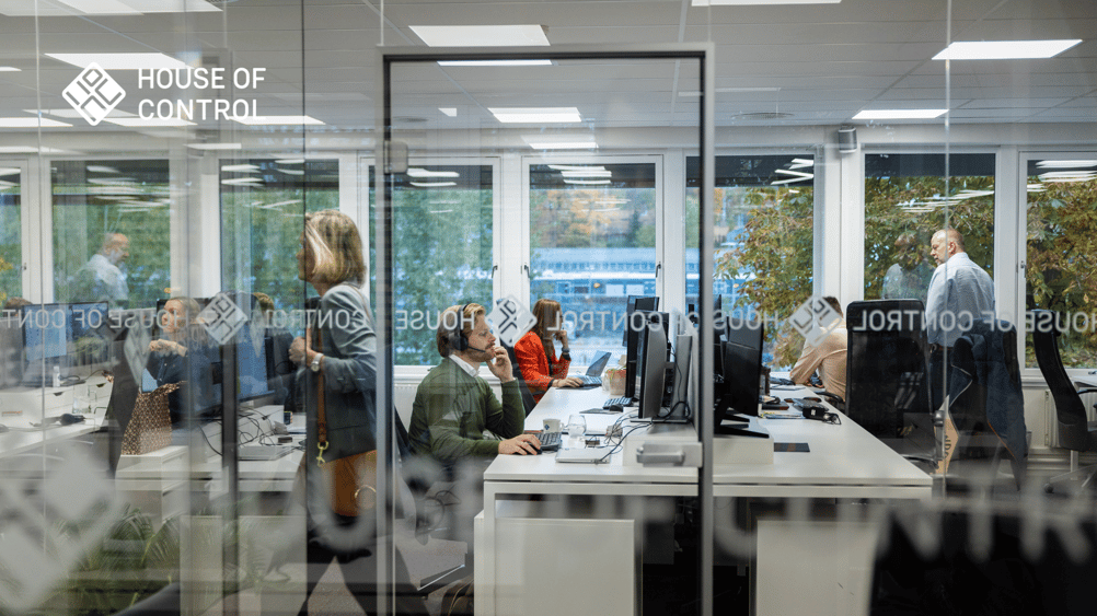 House of Control employees working at a busy office