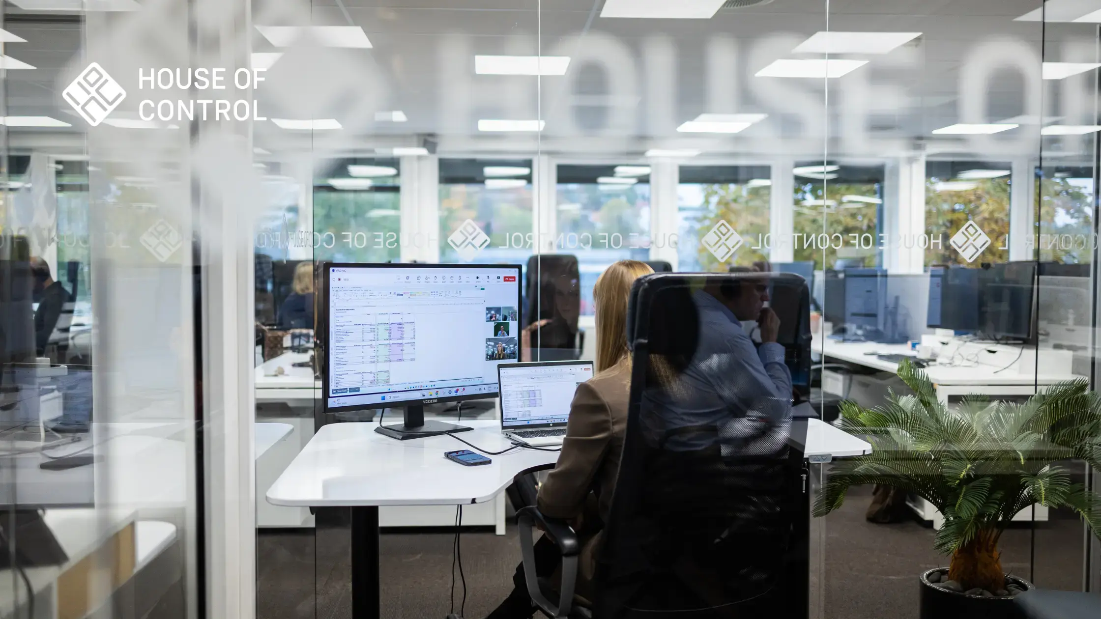 A woman is sitting at her desk in the office