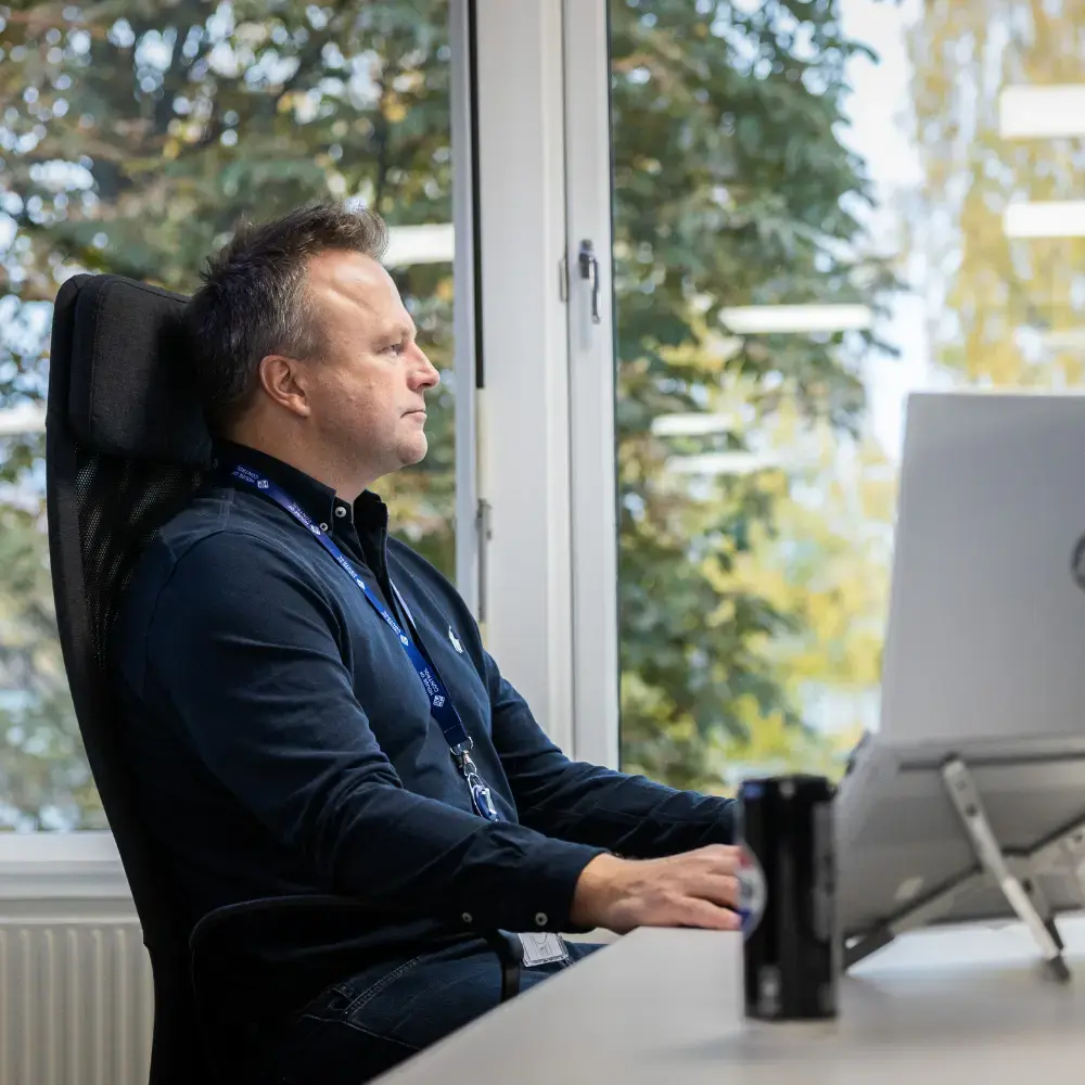 A man sitting in front of the pc at the House of Control office