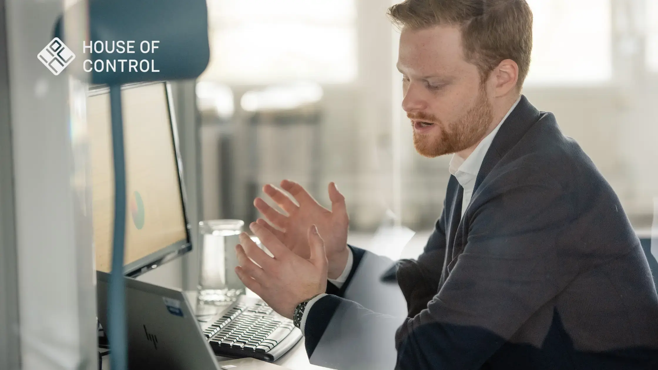 A House of Control employee working in an office, explaining IFRS 16 on the screen