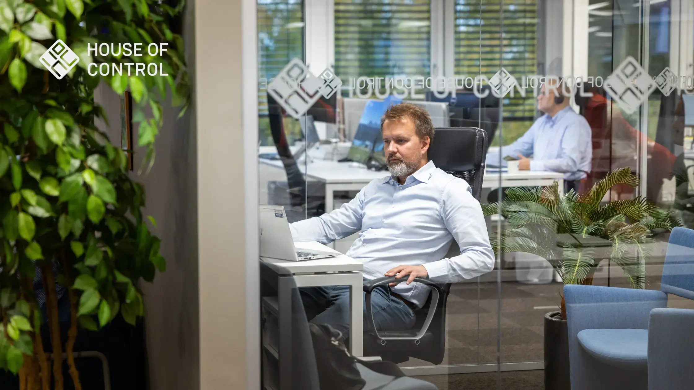 An employee at House of control, sitting down while in a meeting room