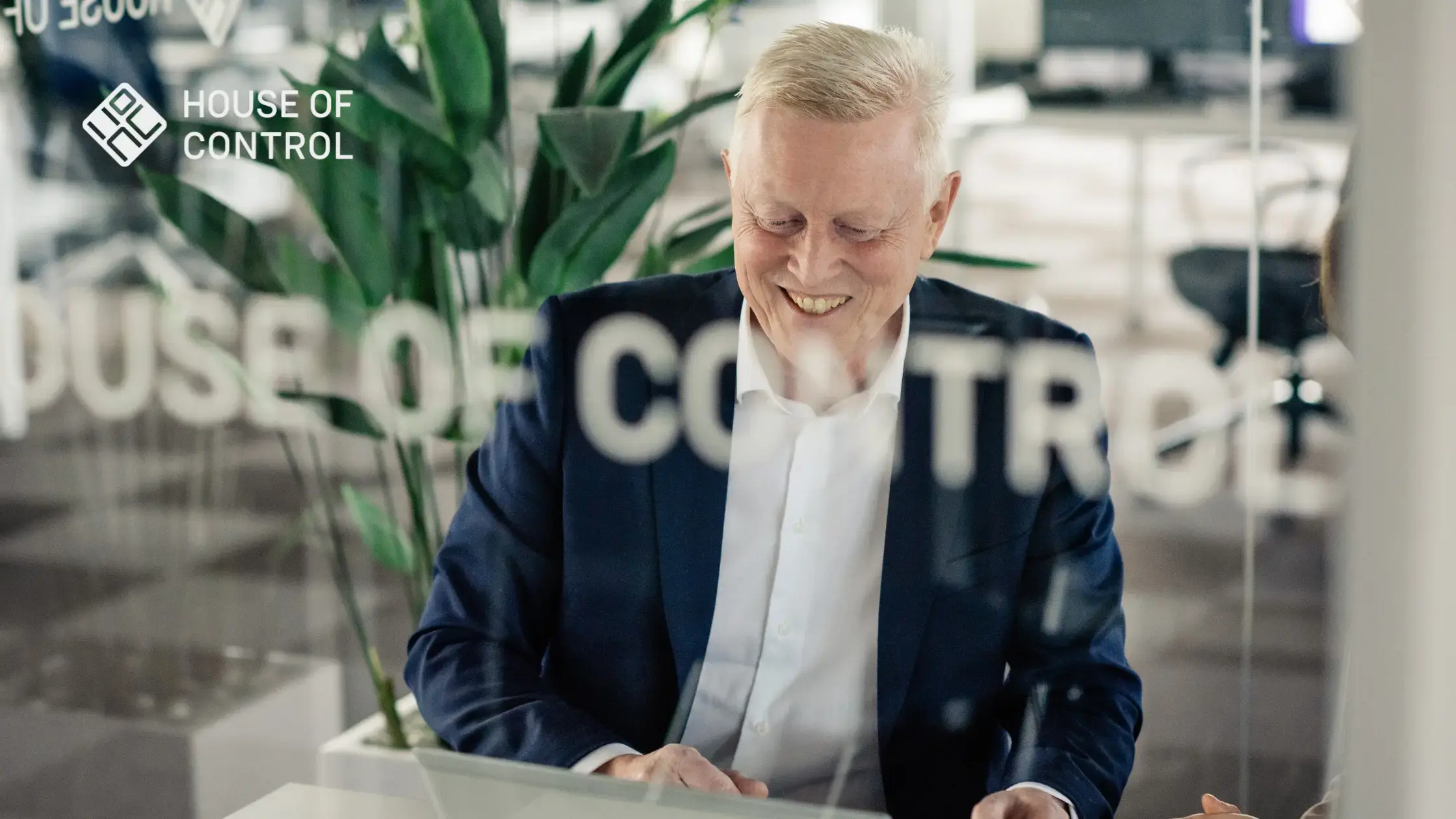A House of Control employee sitting down and looking at his laptop