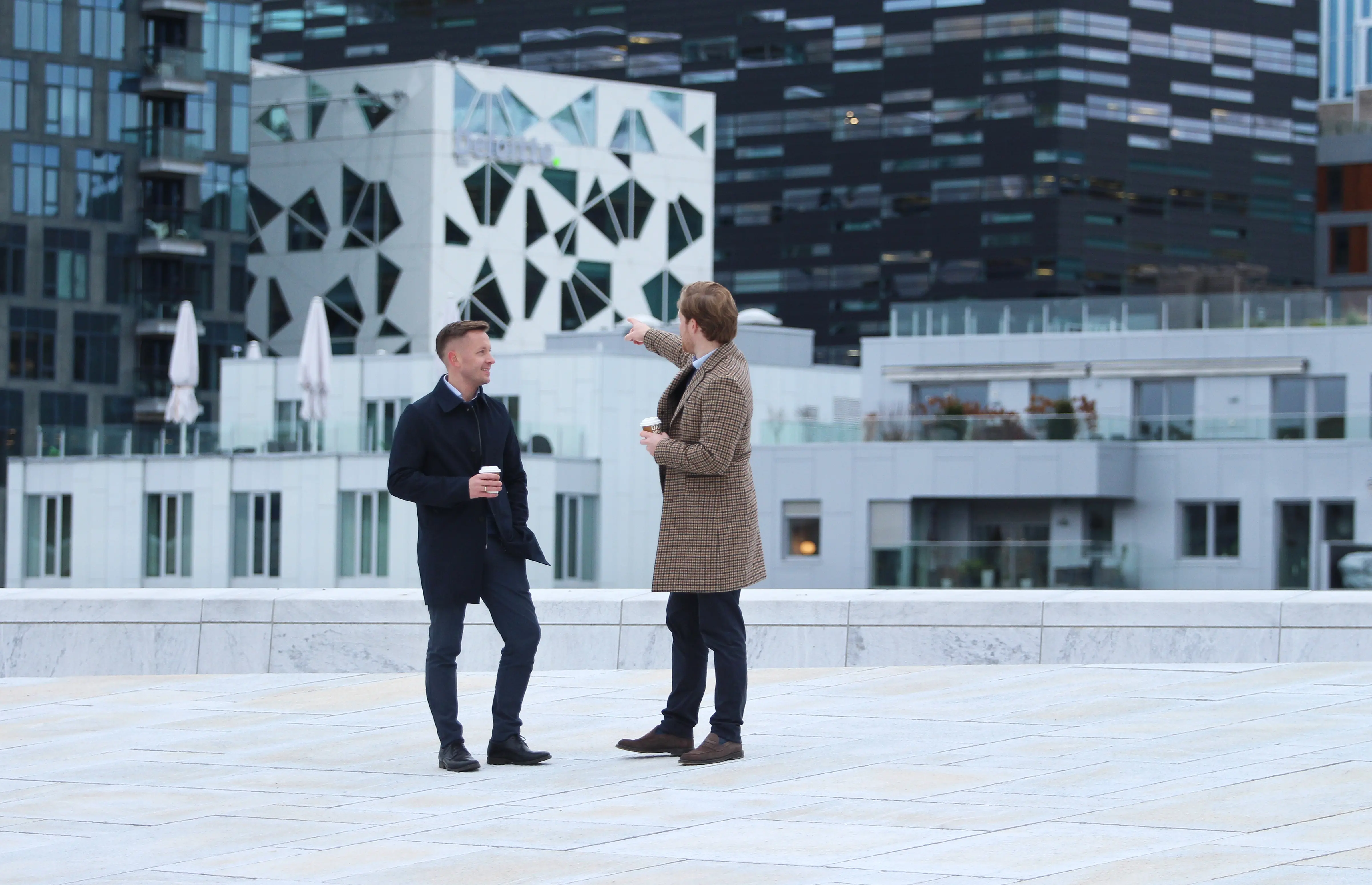 Two men standing at the top of Oslo Opera House