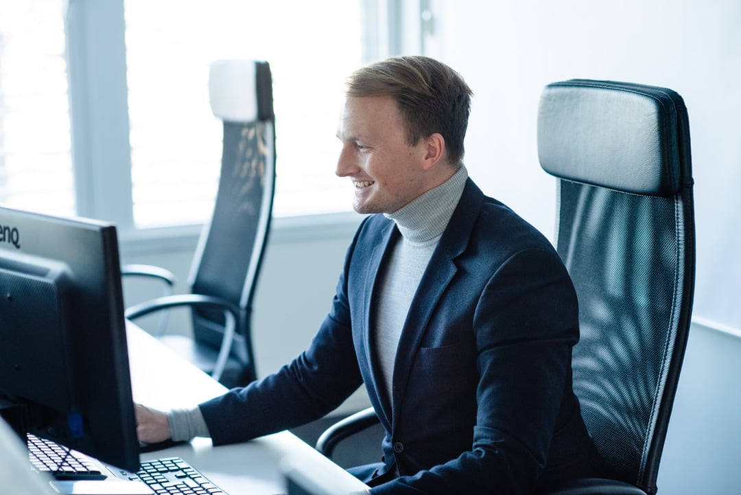 An employee at House of Control sitting down and viewing his emails